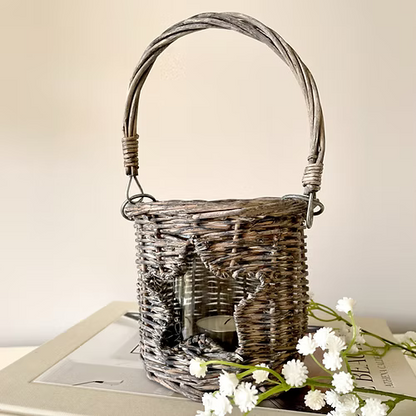 Star shaped cut out wicker candle holder with glass insert, available in two sizes, adding country charm to a room.