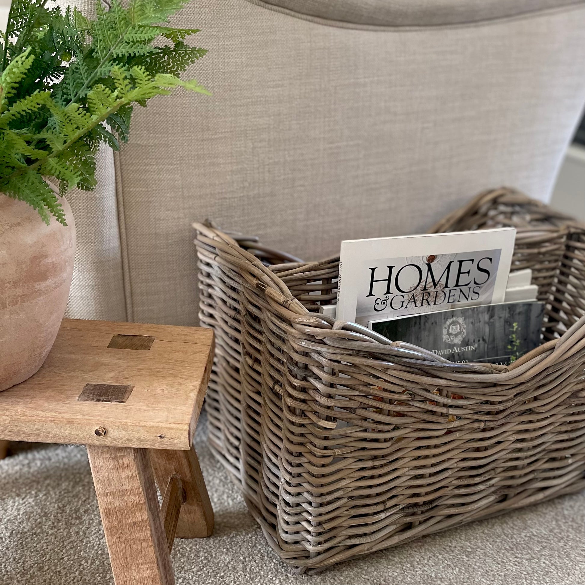 Handmade rattan magazine storage basket with two compartments.