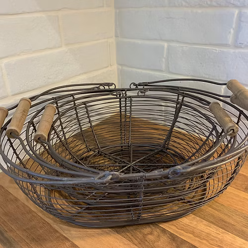Sturdy metal wire baskets with wooden handles, perfect for storing eggs or small kitchen essentials