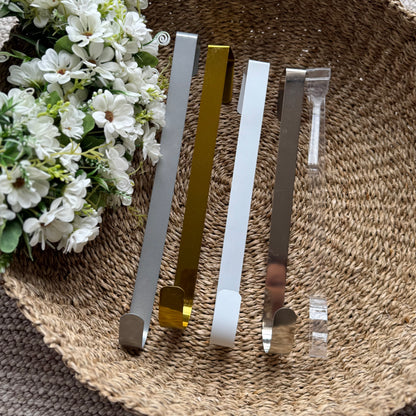 Assorted coloured metal wreath holders displayed together, showcasing their sturdy design and versatile home decor use.